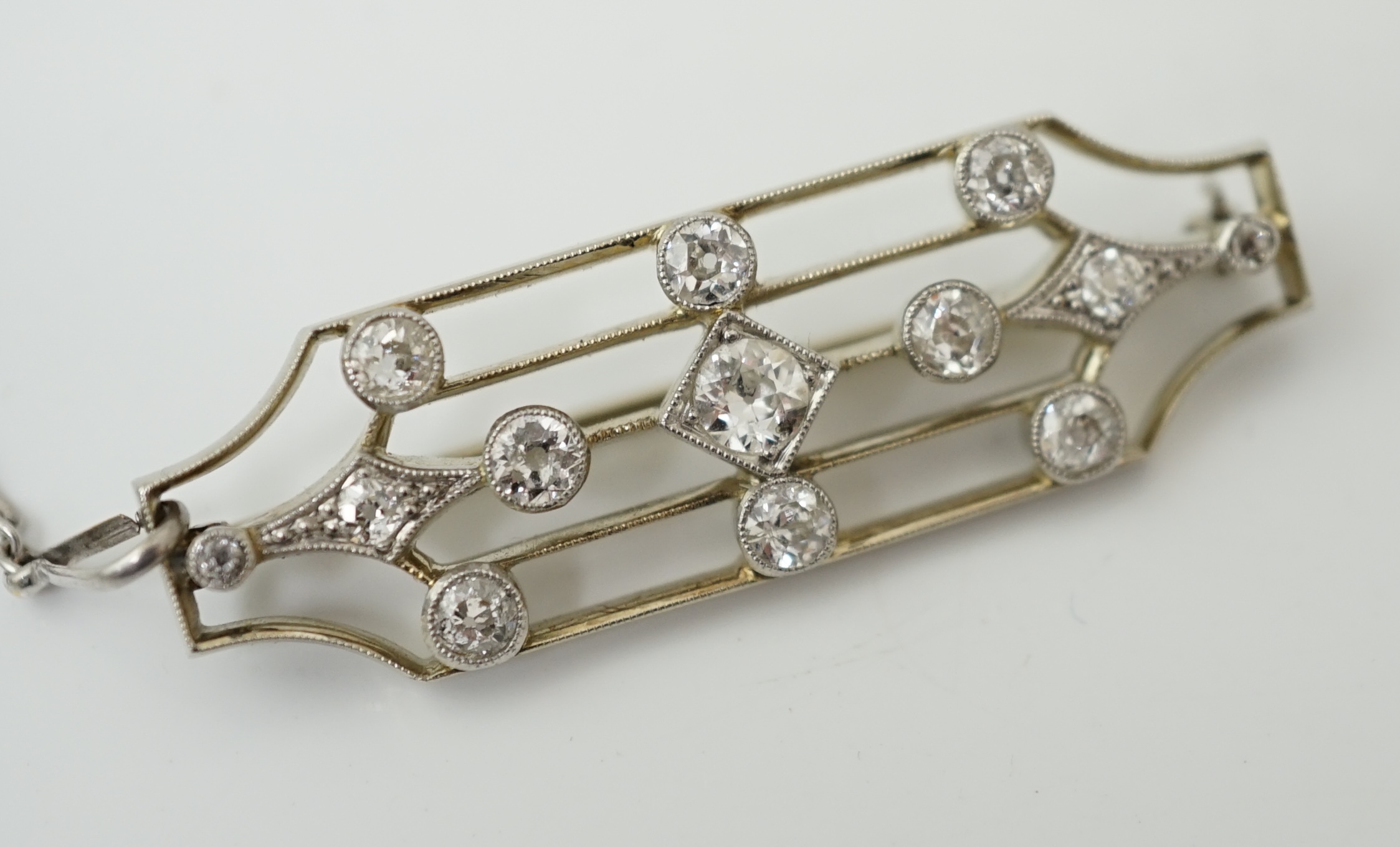An early 20th century 18ct white gold, platinum and millegrain set diamond cluster openwork brooch